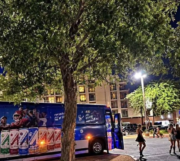 Party bus and crowd at night in Scottsdale